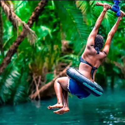 Guest swinging over the water at Chemka